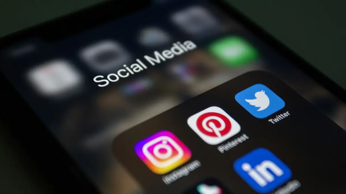 Phone with several social media app icons on the screen