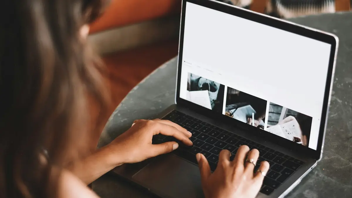 Hands typing on a laptop during an online class