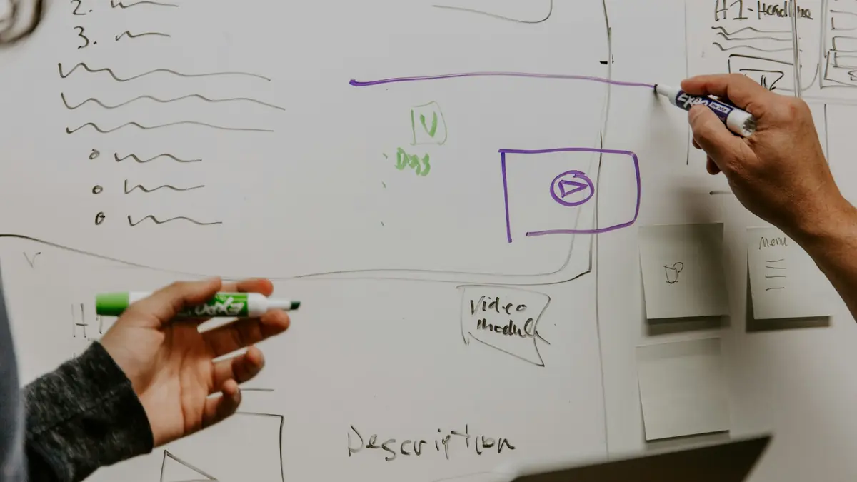 Person drawing a flowchart on a whiteboard