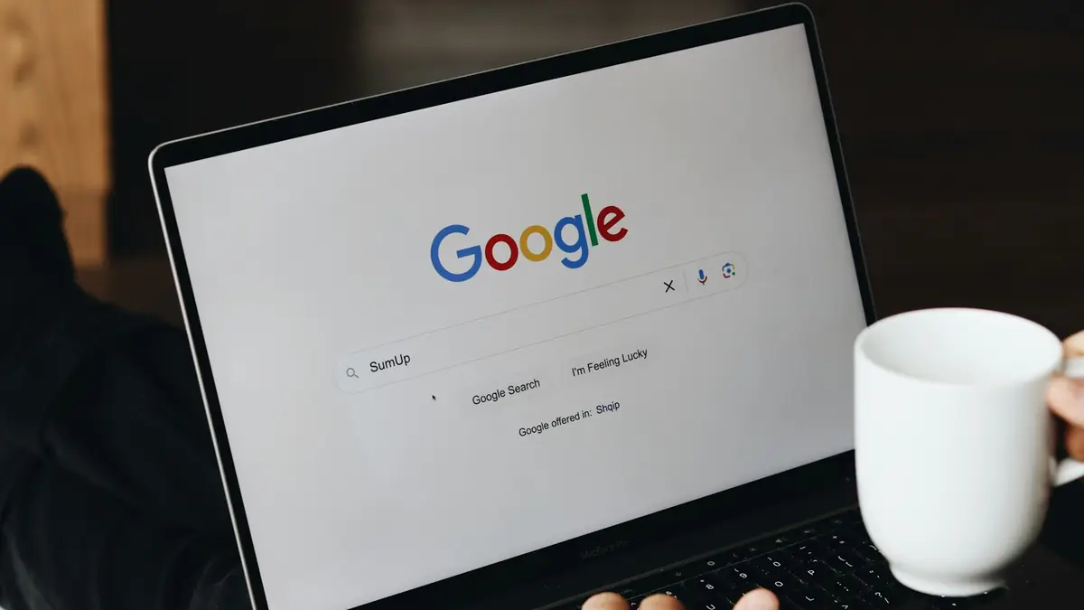 Person typing a search on their laptop