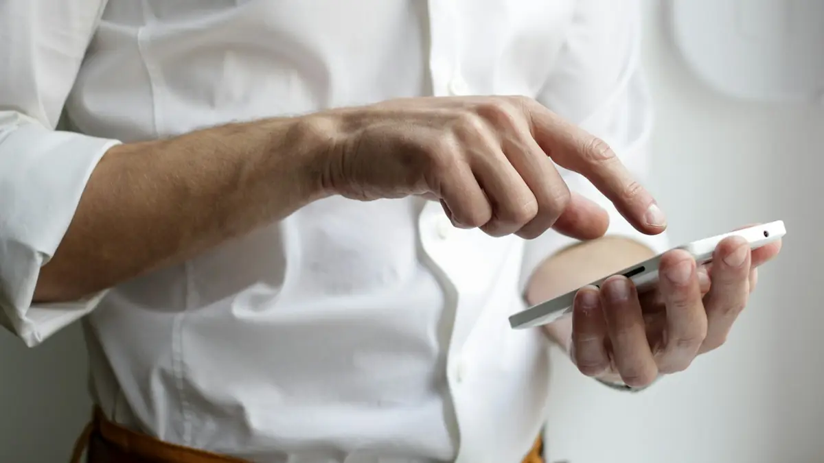 Person holding a smartphone with the screen on