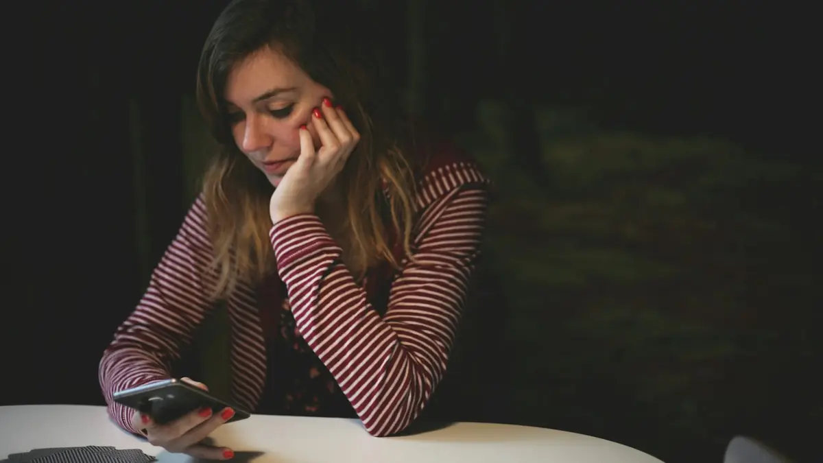 Woman smiling while reading a message on her phone