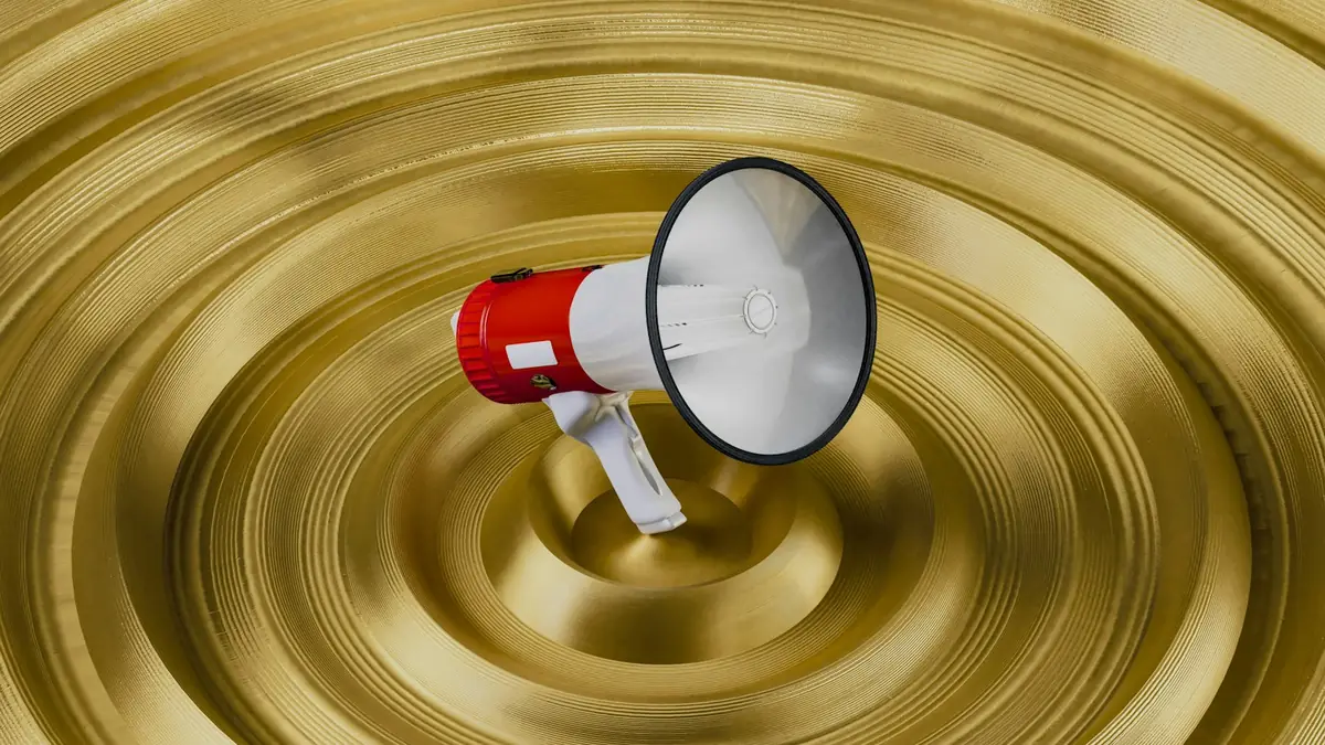 Megafone vermelho e branco sobre um fundo dourado